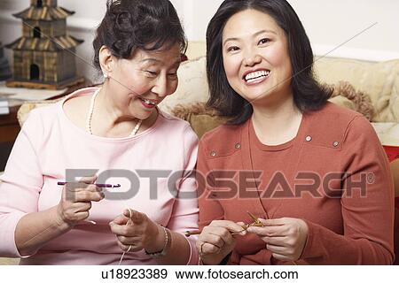 Close-up of a daughter and her mother knitting View Large Photo Image Stock Photo - Close-up of a daughter and her mother knitting. Fotosearch