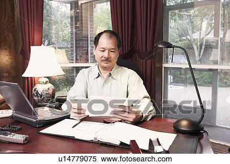 Stock Photography - Close-up of a senior man holding a letter. Fotosearch