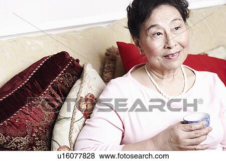 Close-up of a senior woman holding a tea cup View Large Photo Image Stock Photo - Close-up of a senior woman holding a tea cup. Fotosearch