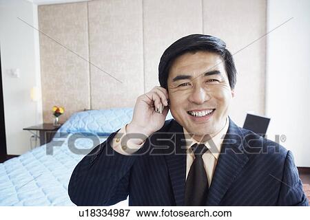 Portrait of a businessman talking on a mobile phone smiling View Large Photo Image Stock Photo - Portrait of a businessman talking on a mobile phone smiling. Fotosearch