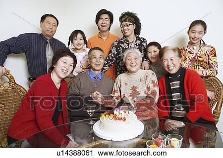 Stock Image - Portrait of a family at a birthday party. Fotosearch