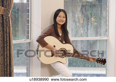 Portrait of a girl playing the guitar View Large Photo Image Stock Image - Portrait of a girl playing the guitar. Fotosearch