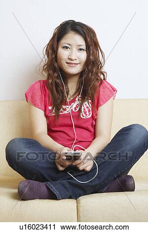 Portrait of a young woman listening to music View Large Photo Image Stock Image - Portrait of a young woman listening to music. Fotosearch