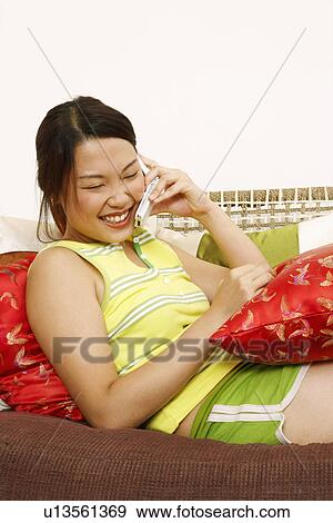 Stock Photo - Young woman using a mobile phone. Fotosearch