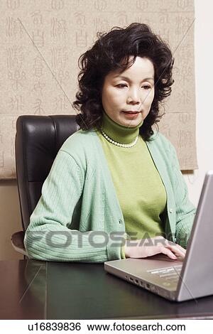 Stock Photograph - Close-up of a businesswoman using a computer. Fotosearch