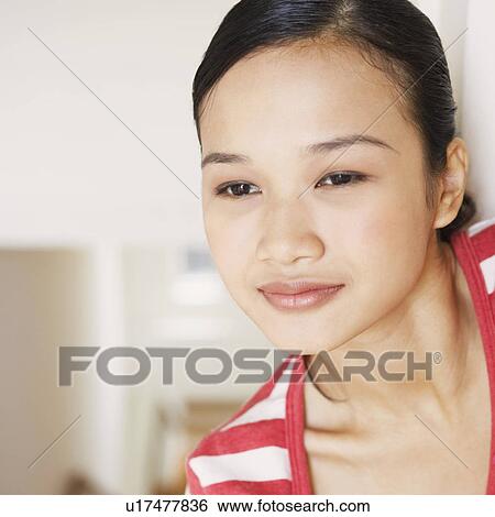 Stock Photograph - Close-up of a young woman smiling. Fotosearch