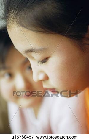 Stock Photo - Close-up of two sisters. Fotosearch