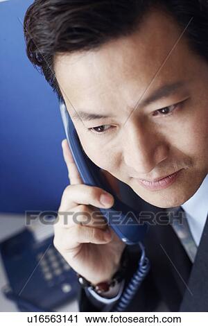High angle view of a businessman talking on the telephone View Large Photo Image Stock Image - High angle view of a businessman talking on the telephone. Fotosearch