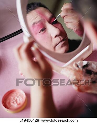 High angle view of a mid adult man applying eyeliner View Large Photo Image Stock Photo - High angle view of a mid adult man applying eyeliner. Fotosearch