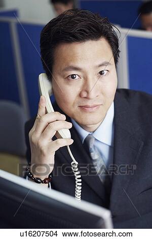 Portrait of a businessman talking on the telephone View Large Photo Image Picture - Portrait of a businessman talking on the telephone. Fotosearch