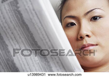 Portrait of a businesswoman holding a financial newspaper View Large Photo Image Stock Image - Portrait of a businesswoman holding a financial newspaper. Fotosearch