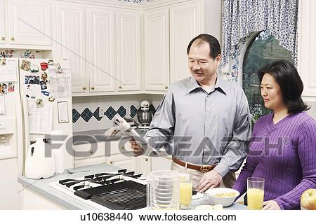 Close-up of a couple in the kitchen View Large Photo Image Stock Image - Close-up of a couple in the kitchen. Fotosearch