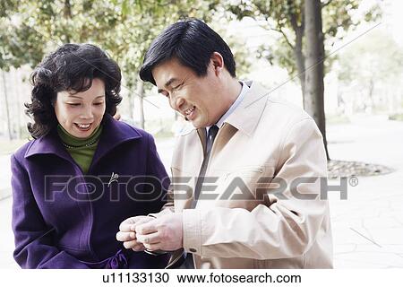 Stock Image - Close-up of a mature couple smiling together. Fotosearch
