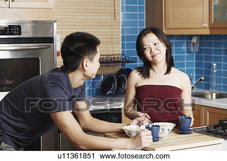 Close-up of a young couple holding cups in the kitchen View Large Photo Image Stock Image - Close-up of a young couple holding cups in the kitchen. Fotosearch