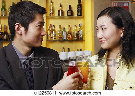 Close-up of a young couple looking at each other View Large Photo Image Stock Image - Close-up of a young couple looking at each other. Fotosearch