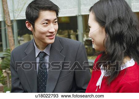 Close-up of a young couple looking at each other View Large Photo Image Stock Image - Close-up of a young couple looking at each other. Fotosearch