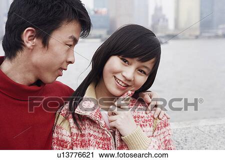 Close-up of a young couple smiling View Large Photo Image Stock Image - Close-up of a young couple smiling. Fotosearch