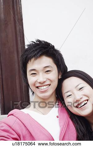 Portrait of a teenage boy smiling with a young woman View Large Photo Image Picture - Portrait of a teenage boy smiling with a young woman. Fotosearch
