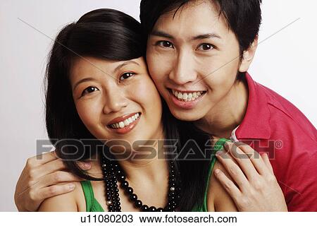 Stock Image - Portrait of a young couple smiling. Fotosearch
