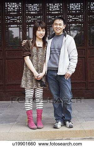 Stock Image - Portrait of a young couple smiling. Fotosearch