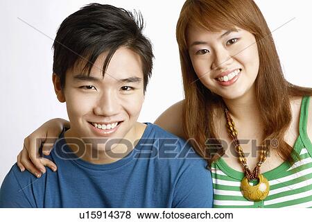 Stock Photo - Portrait of a young couple smiling. Fotosearch