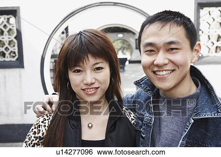 Stock Photograph - Portrait of a young couple smiling. Fotosearch