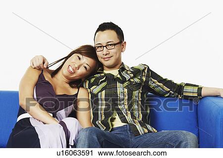 Stock Image - Portrait of a young woman leaning on a young man's shoulder. Fotosearch