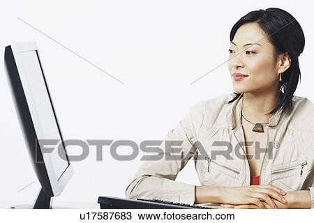 Close-up of a businesswoman smiling near a computer View Large Photo Image Stock Image - Close-up of a businesswoman smiling near a computer. Fotosearch