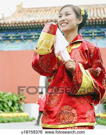 Stock Photograph - Low angle view of a young woman in the traditional clothing. Fotosearch