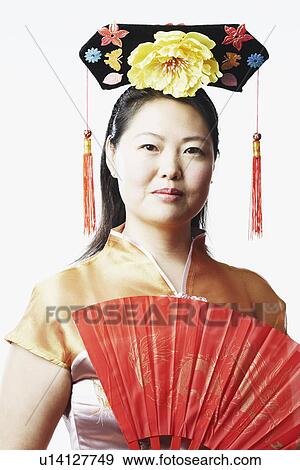 Portrait of a mid adult woman holding a folding fan View Large Photo Image Stock Photo - Portrait of a mid adult woman holding a folding fan. Fotosearch