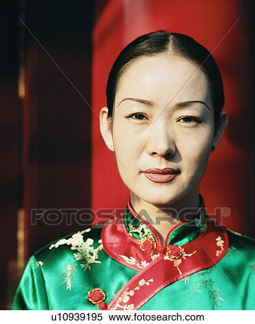 Stock Photography - Portrait of a young woman in a traditional dress. Fotosearch