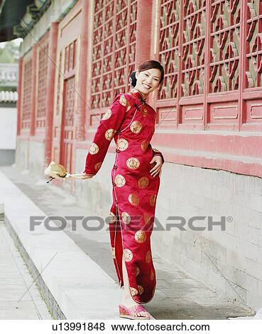 Portrait of a young woman standing in the traditional clothing and smiling View Large Photo Image Stock Photo - Portrait of a young woman standing in the traditional clothing and smiling. Fotosearch