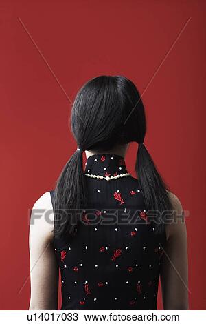 Rear view of a young woman standing View Large Photo Image Stock Image - Rear view of a young woman standing. Fotosearch