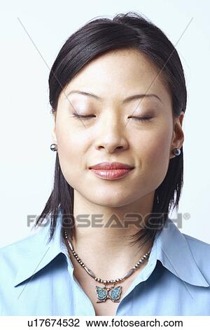 Close-up of a businesswoman thinking with her eyes closed View Large Photo Image Stock Image - Close-up of a businesswoman thinking with her eyes closed. Fotosearch