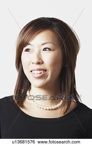Close-up of a young woman smiling View Large Photo Image Stock Photograph - Close-up of a young woman smiling. Fotosearch