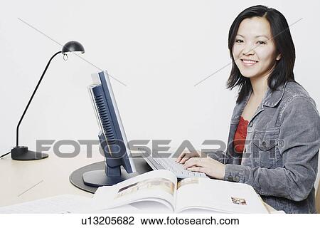 Stock Image - Portrait of a businesswoman using a computer. Fotosearch