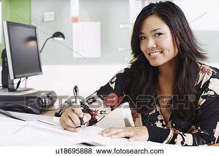 Portrait of a businesswoman writing with a pen View Large Photo Image Stock Photo - Portrait of a businesswoman writing with a pen. Fotosearch