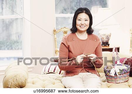 Stock Photo - Portrait of a mature woman knitting. Fotosearch