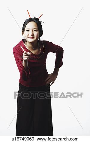 Stock Photo - Portrait of a teenage girl pointing. Fotosearch