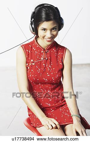 Picture - Portrait of a young woman wearing headphones. Fotosearch