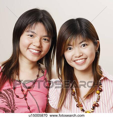 Stock Image - Portrait of three young women smiling. Fotosearch