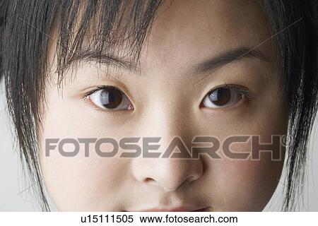 Close-up of a young woman's face View Large Photo Image Stock Photography - Close-up of a young woman's face. Fotosearch