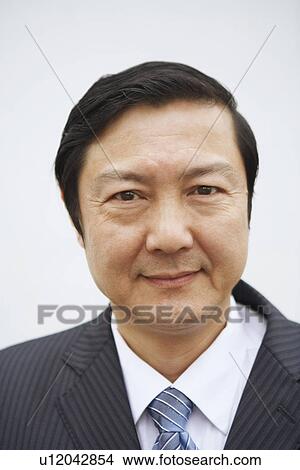 Picture - Portrait of a businessman smiling. Fotosearch