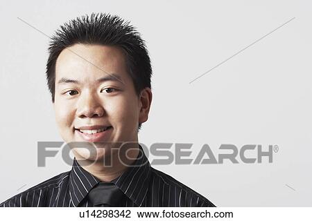 Stock Image - Portrait of a businessman smiling. Fotosearch