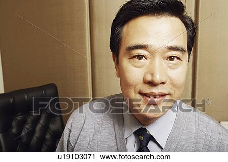 Stock Image - Portrait of a businessman smiling. Fotosearch