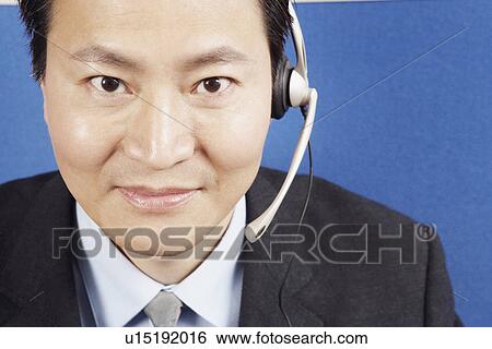 Portrait of a businessman wearing a headset View Large Photo Image Stock Photograph - Portrait of a businessman wearing a headset. Fotosearch