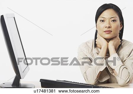 Portrait of a businesswoman sitting near a computer View Large Photo Image Stock Image - Portrait of a businesswoman sitting near a computer. Fotosearch