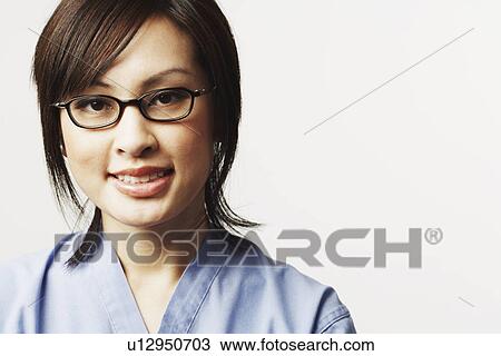 Stock Image - Portrait of a female doctor smiling. Fotosearch