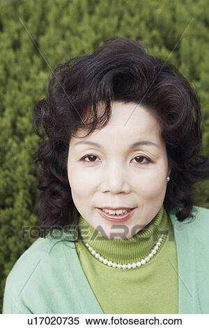 Portrait of a mature woman smiling View Large Photo Image Stock Photography - Portrait of a mature woman smiling. Fotosearch
