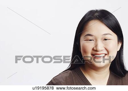 Stock Photo - Portrait of a mid adult woman smiling. Fotosearch